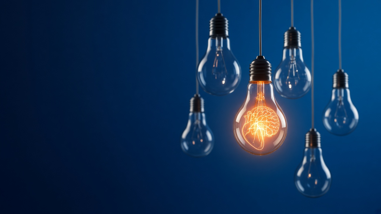 Glowing orange light bulb with a brain-shaped filament among unlit bulbs on a deep blue background